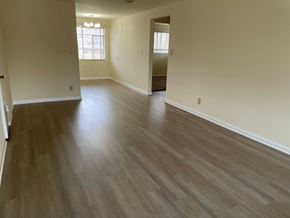 Kettering apartment for rent - an empty living room with wooden flooring and white walls