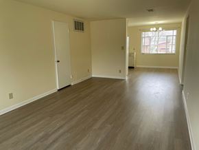 Kettering apartment for rent - A room with light wood flooring and white walls.