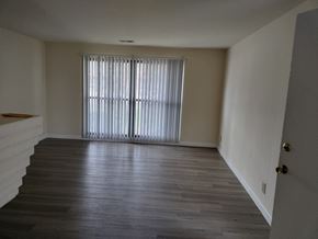 Kettering apartment for rent - an empty living room with wood floors and a large window