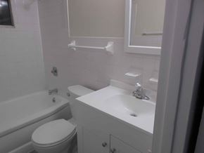 Kettering apartment for rent - A white toilet sits next to a white sink in a bathroom.