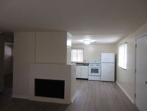 Kettering apartment for rent - A white fireplace in a room with a refrigerator and a window.