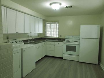 Kettering apartment for rent - A kitchen with white appliances and cabinets.