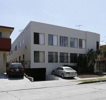 Los Angeles apartment for rent - a white building with two cars parked in front of it