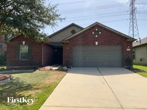 Katy house for rent - A brick house with a garage door is for sale.