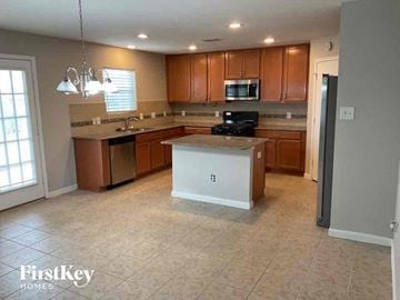 Katy house for rent - A kitchen with wooden cabinets and a white island.