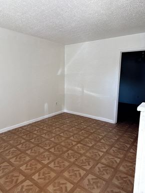 Copperas Cove apartment for rent - an empty room with a wooden floor and a black door
