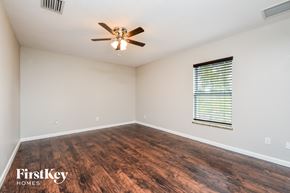 Port Charlotte house for rent - the spacious living room with hardwood flooring and a ceiling fan