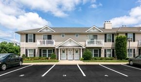 Lindenhurst apartment for rent - the front of an apartment building with a parking lot