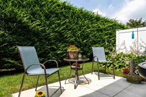 Lindenhurst apartment for rent - a patio with three chairs and a table on a patio