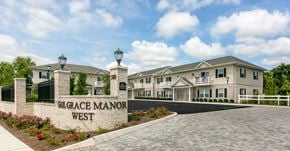 Lindenhurst apartment for rent - an exterior view of a large building with a sign that reads garage manor west