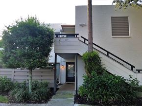 Bradenton house for rent - the entrance to a building with a staircase and a tree