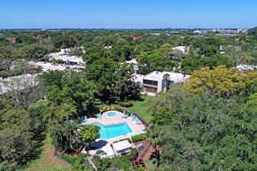 Bradenton house for rent - a aerial view of the resort with a pool and trees