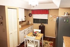 Bradenton house for rent - a small kitchen with a table and a refrigerator