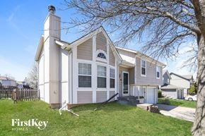 Kansas City house for rent - a white and with a yard and a tree