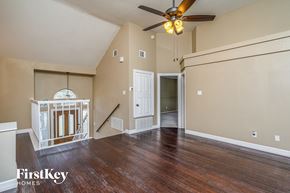 Denton house for rent - the living room of an empty house with a ceiling fan