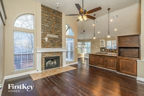Denton house for rent - the kitchen and living room of an empty house with a fireplace