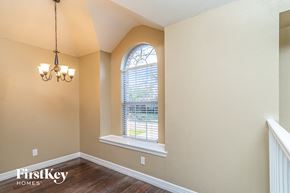 Denton house for rent - an empty room with a window and a staircase