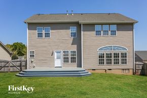 Monroe house for rent - a house with a deck and a grassy yard
