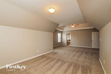 Denver house for rent - a living room with carpet and a ceiling fan