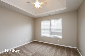 Denver house for rent - a bedroom with a ceiling fan and a window