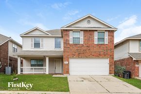 Fort Worth house for rent - a brick house with a white garage door