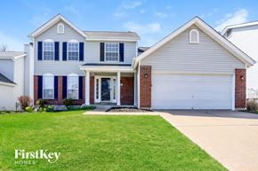 Fenton house for rent - A house with a garage and a driveway in front of it.