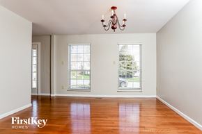 Fenton house for rent - A room with a chandelier and two windows.