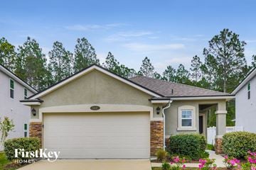 Orange Park house for rent - a home with a white garage door in front of it