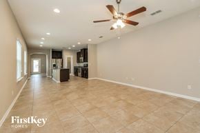 Orange Park house for rent - a spacious living room with tile flooring and a ceiling fan