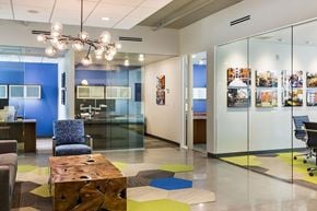 Minneapolis apartment for rent - A modern office space with a blue accent wall and a glass partition.