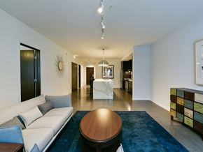 Minneapolis apartment for rent - A modern living room with a white sofa and a wooden coffee table.