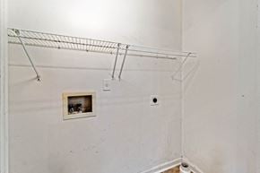 Jacksonville house for rent - A white wall with a wire shelf and a small picture frame.