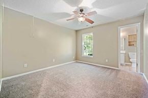 Jacksonville house for rent - A room with a ceiling fan and a window.