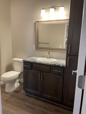 Hickman apartment for rent - a bathroom with a toilet and a sink and a mirror