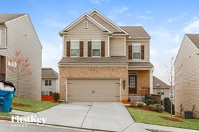 Lawrenceville house for rent - a tan house with a garage door in front of it