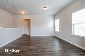 Lawrenceville house for rent - the spacious living room with wood flooring and white walls