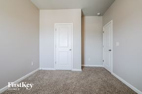 Lawrenceville house for rent - a bedroom with a white door and a carpeted floor