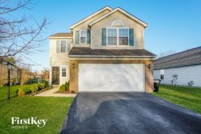 Columbus house for rent - a house with a white garage door on a driveway