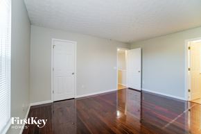 Columbus house for rent - a living room with wood floors and white walls and two doors