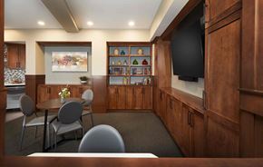 Grand Rapids apartment for rent - a conference room with a table and chairs and a television
