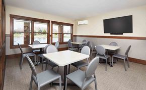 Grand Rapids apartment for rent - a dining room with tables and chairs and a television