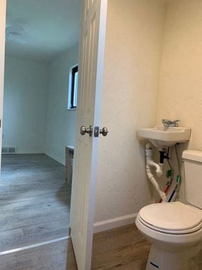 East Mckeesport apartment for rent - A white toilet with a white tank and pipes on the wall.