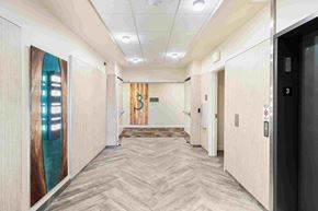 Happy Valley apartment for rent - a hallway with doors in a building with wood floors and white walls