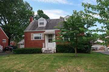 Cincinnati house for rent - A red brick house with a white door and a small porch.