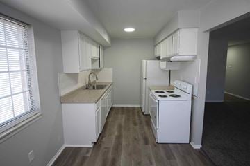 Royal Oak apartment for rent - a kitchen with white appliances and white cabinets