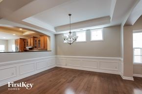 Indian Trail house for rent - an empty dining room with white wainscoting and a chandelier