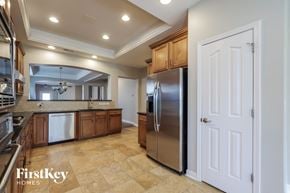 Indian Trail house for rent - a large kitchen with stainless steel appliances and wooden cabinets