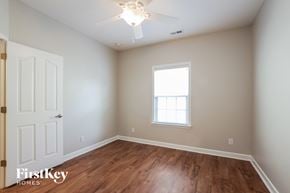 Indian Trail house for rent - a bedroom with wood flooring and a ceiling fan