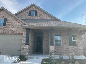 Celina house for rent - a brown brick house with a garage door