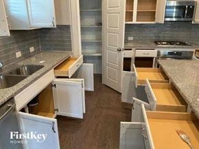 Celina house for rent - a kitchen with a bunch of drawers and a door